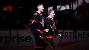 Ottawa Senators captain Brady Tkachuk (7) skates beside former Senators captain Daniel Alfredsson as he heads to make the ceremonial puck drop before first period NHL hockey action against the Boston Bruins in Ottawa, on Tuesday, Oct. 18, 2022. (Justin Tang/THE CANADIAN PRESS)