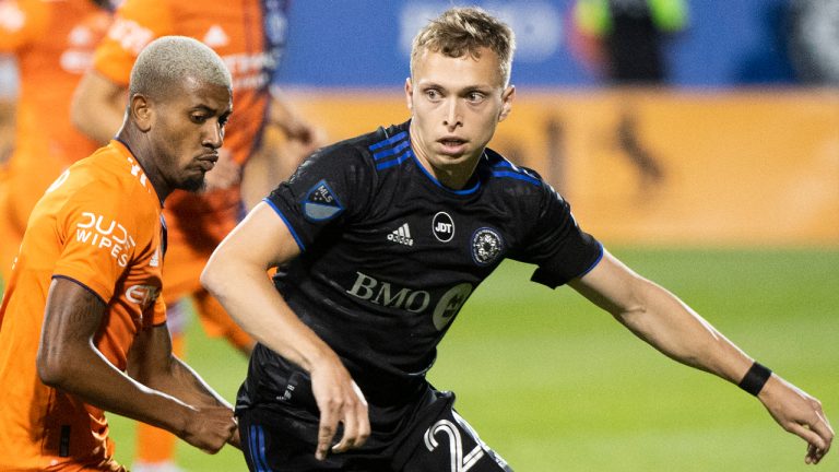 CF Montreal's Alistair Johnston, right, breaks away from New York City FC's Thiago during second half MLS soccer action in Montreal, Saturday, July 30, 2022. (Graham Hughes/CP)