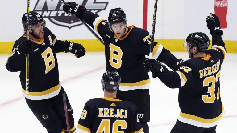 Boston Bruins' Taylor Hall (71) celebrates his goal with David Pastrnak (88), David Krejci (46) and Patrice Bergeron (37) during overtime of an NHL hockey game against the Minnesota Wild, Saturday, Oct. 22, 2022, in Boston. (Michael Dwyer/AP)