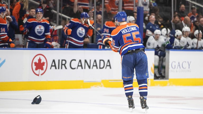 Edmonton Oilers' Dylan Holloway (55) celebrates a hat trick against the Vancouver Canucks during third period preseason action in Edmonton on Monday, October 3, 2022. (Jason Franson/CP)