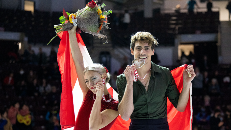Ice dance gold medalist Canada’s Piper Gilles and Paul Poirier ham it up during victory ceremonies at Skate Canada International in Mississauga, Ont., on Saturday, October 29, 2022. (CP)
