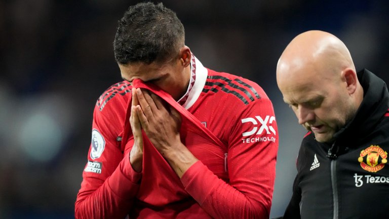 Manchester United's Raphael Varane, left, reacts as he leaves the field after he was injured during the English Premier League soccer match between Manchester United and Chelsea at the Stamford Bridge Stadium in London, Saturday, Oct. 22, 2022. (AP)