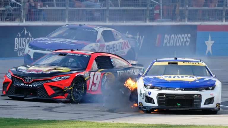 Chase Elliott (9) has his tire catch fire as Martin Truex Jr. (19) and Corey LaJoie (7) drive past during the NASCAR Cup Series auto race at Texas Motor Speedway in Fort Worth, Texas, Sunday, Sept. 25, 2022. (Larry Papke/AP)