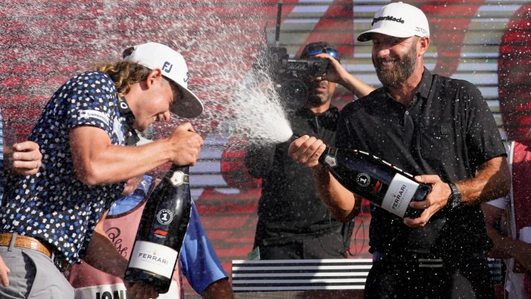 Cameron Smith, left, and Dustin Johnson, right, celebrate after the final round of the LIV Golf Team Championship at Trump National Doral Golf Club, Sunday, Oct. 30, 2022, in Doral, Fla. Johnson's 4 Aces GC team won the team championship. (Lynne Sladky/AP)