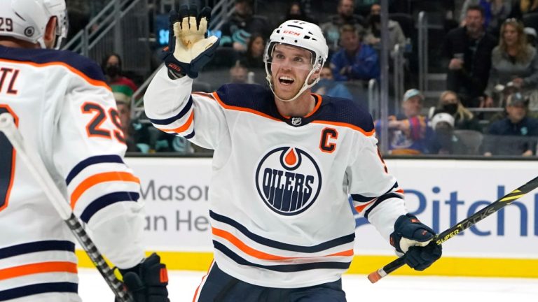 Edmonton Oilers' Connor McDavid reacts to a goal by the team with Leon Draisaitl (29) against the Seattle Kraken in the first period of an NHL hockey game Saturday, Dec. 18, 2021, in Seattle. (Elaine Thompson/AP)