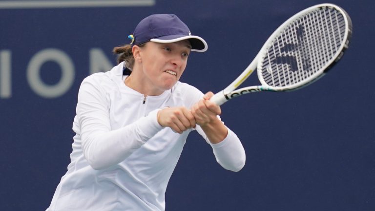 Iga Swiatek of Poland returns to Qinwen Zheng of China at the San Diego Open tennis tournament Thursday, Oct. 13, 2022, in San Diego. (Gregory Bull/AP)