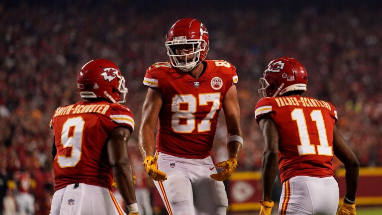 Kansas City Chiefs tight end Travis Kelce (87) is congratulated by teammates wide receivers JuJu Smith-Schuster (9) and Marquez Valdes-Scantling (11) after scoring during the first half of an NFL football game against the Las Vegas Raiders Monday, Oct. 10, 2022, in Kansas City, Mo. (Charlie Riedel/AP Photo)