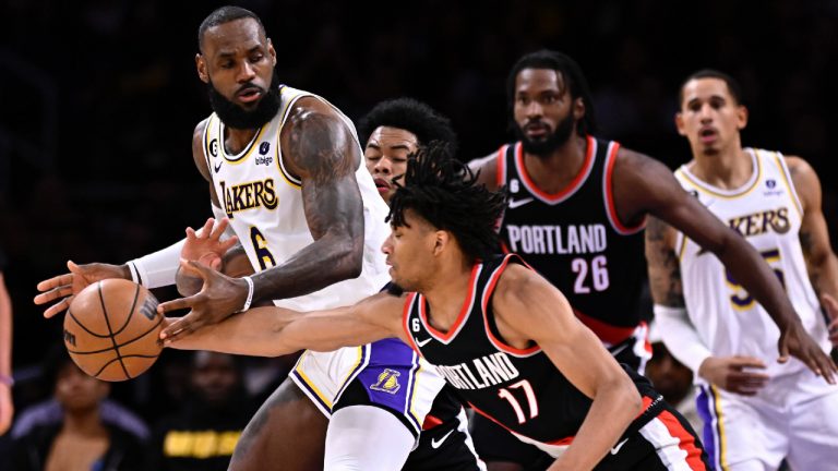 Portland Trail Blazers guard Shaedon Sharpe, center, steals the ball away from Los Angeles Lakers forward LeBron James, left, during the second half of an NBA basketball game Sunday, Oct. 23, 2022, in Los Angeles. (Alex Gallardo/AP)