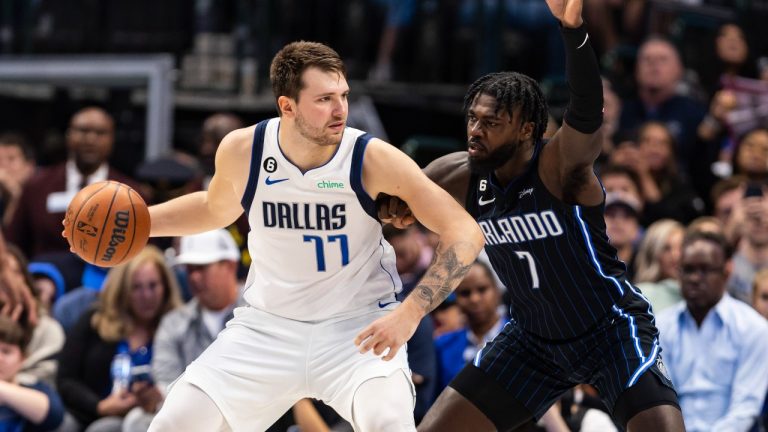 Dallas Mavericks guard Luka Doncic (77) battles Orlando Magic guard Kevon Harris (7) for space during the second half of an NBA basketball game, Sunday, Oct. 30, 2022, in Dallas. (Brandon Wade/AP)