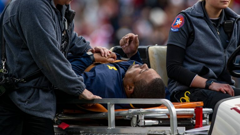 Michigan running game coordinator Mike Hart was carted off the field on a backboard during the first half of an NCAA college football game against Indiana, Saturday, Oct. 8, 2022, in Bloomington, Ind. (Doug McSchooler/AP)