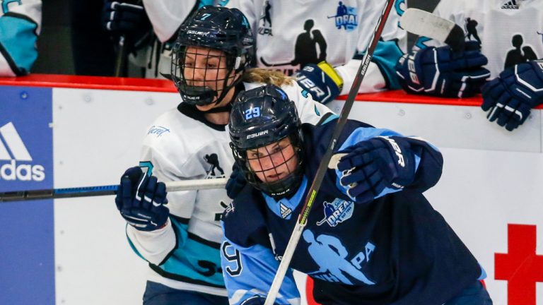 Marie-Philip Poulin, right, checks Nicole Kosta during first period PWHPA Dream Tour hockey action in Calgary, Monday, May 24, 2021. (Jeff McIntosh/CP)