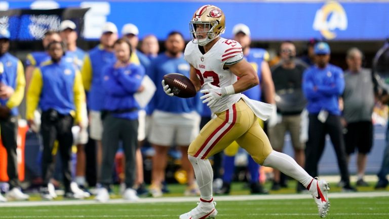 San Francisco 49ers running back Christian McCaffrey rolls out before passing for a touchdown on a trick play during the first half of an NFL football game against the Los Angeles Rams Sunday, Oct. 30, 2022, in Inglewood, Calif. (Ashley Landis/AP)