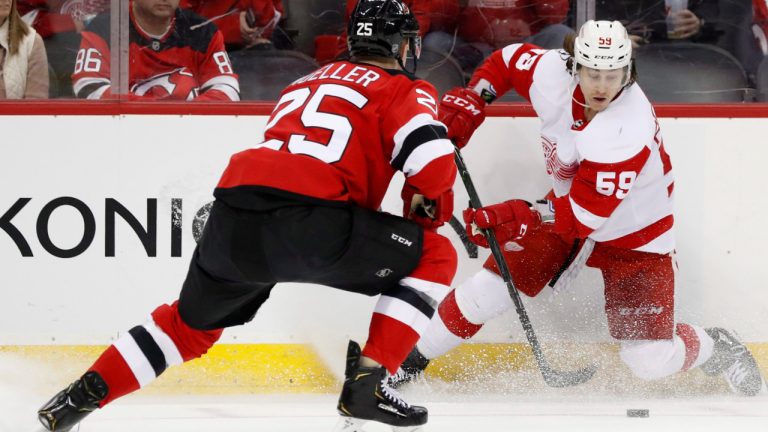 New Jersey Devils defenseman Mirco Mueller (25) challenges Detroit Red Wings left wing Tyler Bertuzzi (59) during the first period of an NHL hockey game, Thursday, Feb. 13, 2020, in Newark, N.J. (Kathy Willens/AP)