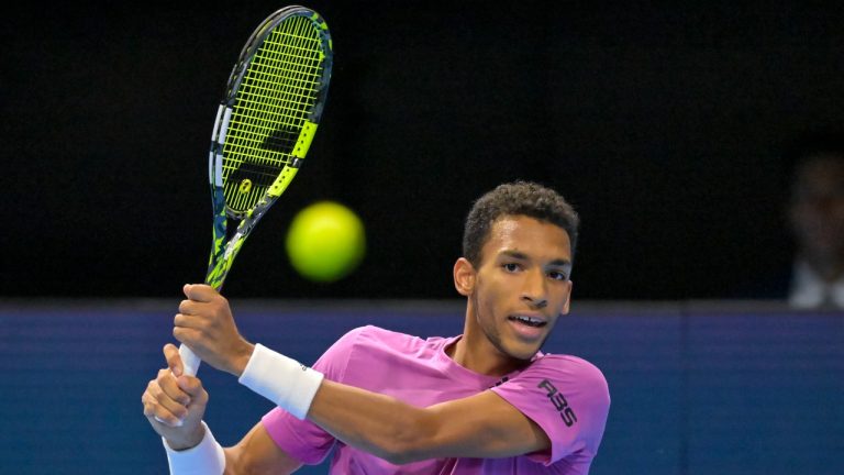 Canada's Felix Auger-Aliassime returns a ball to Kazakhstan's Alexander Bublik during their quarterfinal match at the Swiss Indoors tennis tournament at the St. Jakobshalle in Basel, Switzerland, Friday, Oct. 28, 2022. (Georgios Kefalas/Keystone via AP)