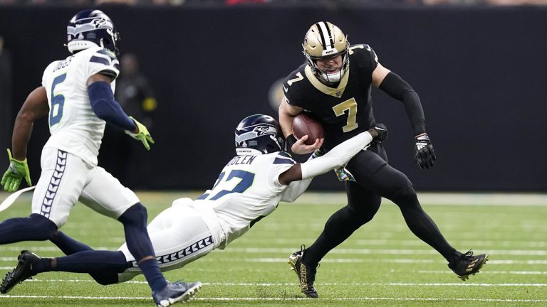 New Orleans Saints' Taysom Hill (7) carries the ball as Seattle Seahawks cornerback Tre Brown tries to make the tackle during an NFL football game in New Orleans, Sunday, Oct. 9, 2022. (Gerald Herbert/AP)