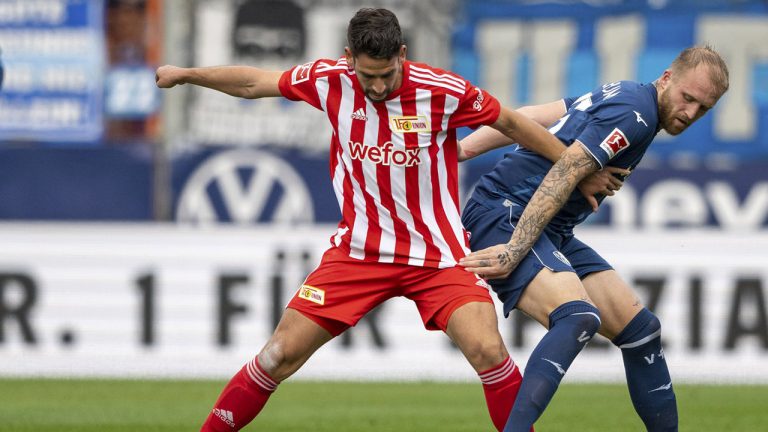 Berlin's Rani Khedira, left, and Bochum's Philipp Hofmann, right, challenge for the ball during the German Bundesliga soccer match between VfL Bochum and 1. FC Union Berlin in Bochum, Germany, Sunday, Oct 23, 2022. (David Inderlied/dpa via AP)