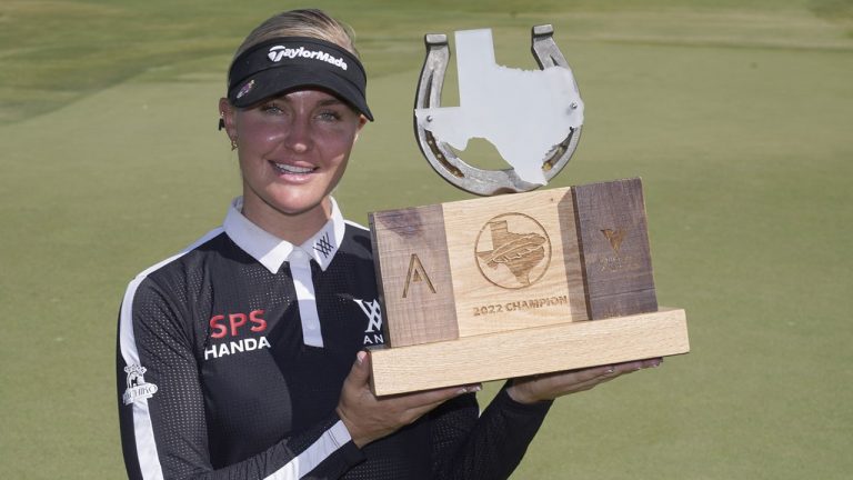 Charley Hull, of England, poses with the champion's trophy after winning the LPGA The Ascendant golf tournament in The Colony, Texas, Sunday, Oct. 2, 2022. (LM Otero/AP)