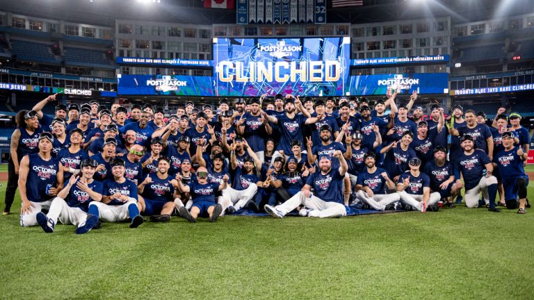 The Toronto Blue Jays and team personnel celebrates clinching a playoff spot after defeating the Boston Red Sox in AL MLB baseball action in Toronto on Friday, September 30, 2022. (Christopher Katsarov/CP)