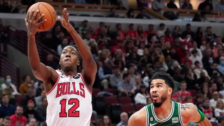 Chicago Bulls' Ayo Dosunmu (12) scores past Boston Celtics' Jayson Tatum, right, and Al Horford during the second half of an NBA basketball game Monday, Oct. 24, 2022, in Chicago. The Bulls won 120-102. (AP Photo/Charles Rex Arbogast)