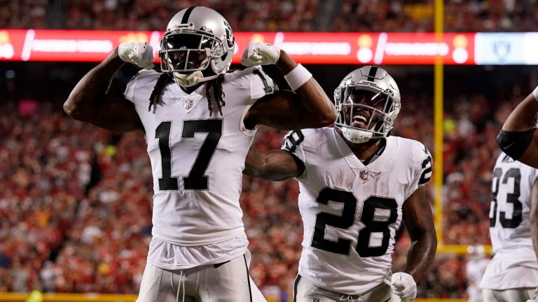 Las Vegas Raiders wide receiver Davante Adams (17) is congratulated by Josh Jacobs (28) after scoring during the first half of an NFL football game against the Kansas City Chiefs. (Charlie Riedel/AP)