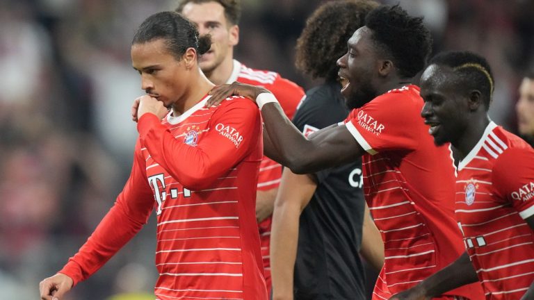Bayern's Leroy Sane, left, and teammate Alphonso Davies celebrate after scoring his side's third goal during the German Bundesliga soccer match between FC Bayern Munich and SC Freiburg at the Allianz Arena in Munich, Germany, Oct. 16, 2022. (Matthias Schrader/AP)