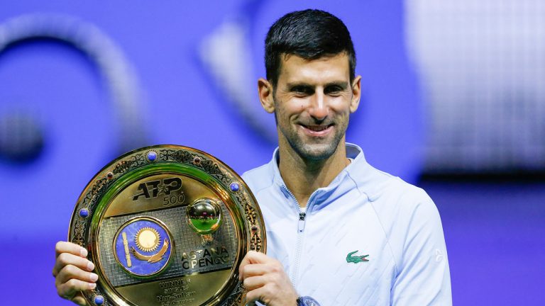 Serbia's Novak Djokovic poses with the trophy after winning the final tennis match of the ATP 500 Astana Open tennis tournament against Stefanos Tsitsipas of Greece in Astana. (Stas Filippov/AP)