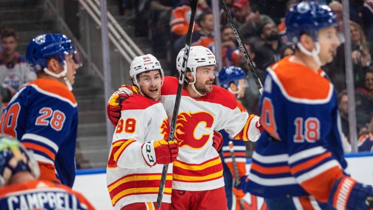 Calgary Flames' Andrew Mangiapane (88) and Rasmus Andersson (4) celebrate a goal against the Edmonton Oilers during first period NHL action in Edmonton on Saturday, October 15, 2022. (Jason Franson/THE CANADIAN PRESS)