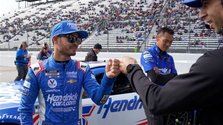 Kyle Larson, left, is congratulated after winning the pole position for Sunday's NASCAR auto race at Martinsville Speedway, Saturday, Oct. 29, 2022, in Martinsville, Va. (Chuck Burton/AP)