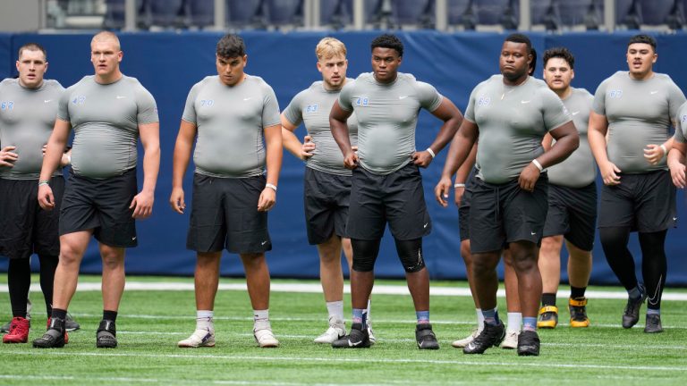 Offensive lineman Jason Godrick, of Nigeria, center, takes part in the NFL International Combine at the Tottenham Hotspur Stadium in London, Tuesday, Oct. 4, 2022. International athletes on Tuesday are taking part in a series of tests in front of NFL evaluators for a potential position in the NFL's International Player Pathway programme. (Kin Cheung/AP) 