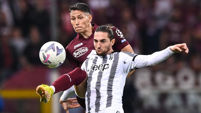 Torino's Sasa Lukic and Juventus' Adrien Rabiot fight for the ball during the Serie A soccer match between Torino and Juventus at Stadio Olimpico Grande Torino in Turin, Italy, Saturday Oct. 15, 2022. (Marco Alpozzi/LaPresse via AP)