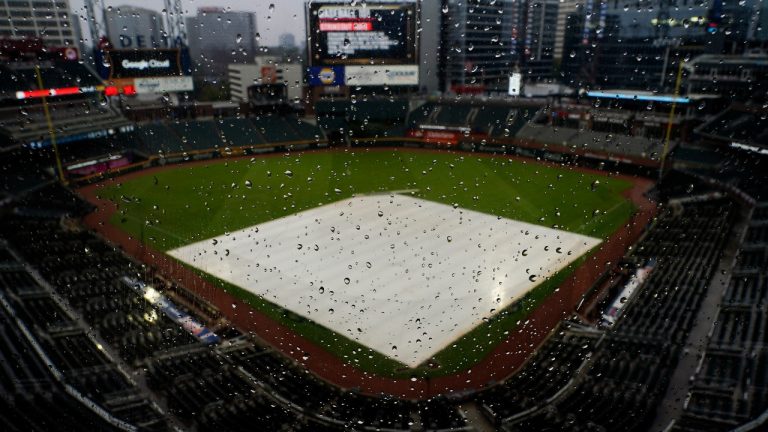 Rain hits a window overlooking Truist Park before Game 2 of baseball's National League Division Series between the Atlanta Braves and the Philadelphia Phillies, Wednesday, Oct. 12, 2022, in Atlanta. The game has been rain delayed. (Brynn Anderson/AP)