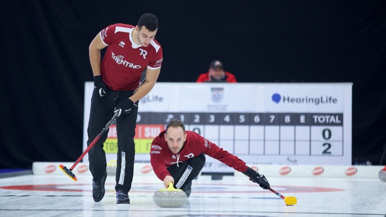 Joël Retornaz (right) throws a stone as Sebastiano Arman (left) prepares to sweep during Draw 8 action in the HearingLife Tour Challenge on Oct. 19, 2022, at the Coca-Cola Centre in Grande Prairie, Alta. (Anil Mungal/GSOC)