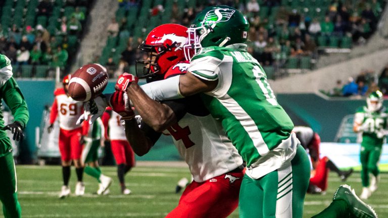 Saskatchewan Roughriders defensive back Rolan Milligan (0) knocks away an intended pass for Calgary Stampeders wide receiver Shawn Bane Jr. (14) during the first half of CFL football action in Regina on Saturday, October 22, 2022. (Heywood Yu/CP)