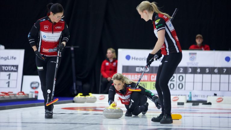 Silvana Tirinzoni (centre) delivers a rock as sweepers Carole Howald (left) and Briar Schwaller-Hürlimann (right) prepare to sweep during Draw 11 action on Oct. 20, 2022, at the Coca-Cola Centre in Grande Prairie, Alta. (Anil Mungal/GSOC)