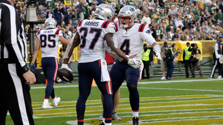 New England Patriots running back Damien Harris (37) celebrates with teammate quarterback Bailey Zappe (4) after scoring on a 5-yard touchdown run during the second half of an NFL football game against the Green Bay Packers. (Mike Roemer/AP)