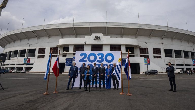 Government sports officials pose for photos outside the National Stadium after the opening ceremony for the creation of "Corporation Juntos 2030," the organization that will create a joint-bid by Chile, Argentina, Uruguay and Paraguay to host the 2030 World Cup soccer tournament, in Santiago, Chile, Friday, Nov. 11, 2022. From left are Chile's National Soccer Association President Pablo Milad, Argentina's Sport Minister Matias Lammens, Chile's Sport Minister Alexandra Benado, Paraguay's Sport Minister Diego Galeano, Uruguay's Sport Minister Sebastian Bauza, Paraguay's National Soccer Association General Secretary Alba Benitez and representative of Uruguay's Soccer Association Eduardo Ache. (Esteban Felix/AP)