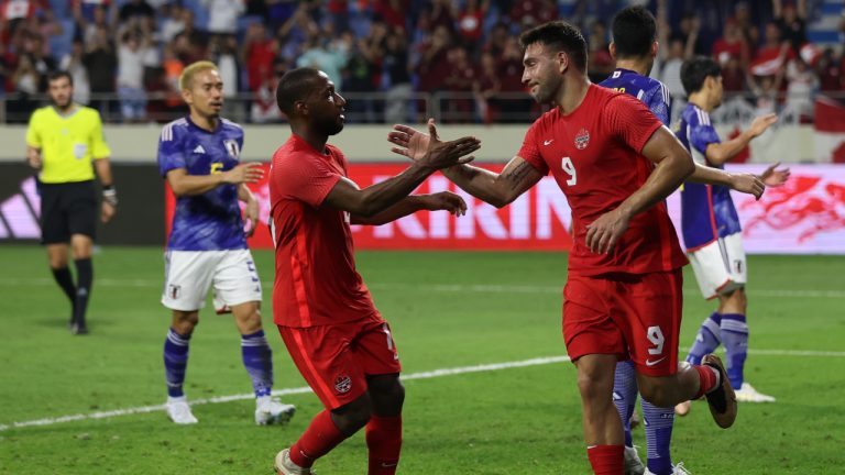 Canada's Lucas Cavallini, right, celebrates after he scored from a penalty kick during a friendly soccer match between Canada and Japan in Dubai. (Christopher Pike/AP)