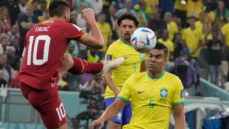Serbia's Dusan Tadic, left, fights for the ball with Brazil's Casemiro during the World Cup group G soccer match between Brazil and Serbia, at the Lusail Stadium in Lusail, Qatar, Thursday, Nov. 24, 2022. (AP)