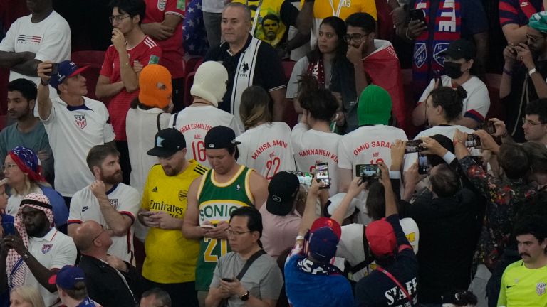 Women wearing shirts with the names and ages of young protesters killed in the demonstrations stand during the World Cup group B soccer match between Iran and the United States at the Al Thumama Stadium in Doha, Qatar, Tuesday, Nov. 29, 2022. (AP)