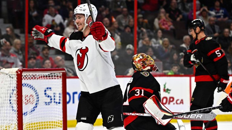 New Jersey Devils right wing Nathan Bastian (14) celebrates his goal as Ottawa Senators goaltender Anton Forsberg (31) looks on during first period NHL hockey action in Ottawa, on Saturday, Nov. 19, 2022. (Justin Tang/CP)