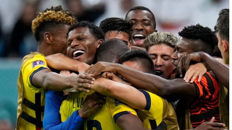 Teammates embrace Ecuador's Enner Valencia after he scored his side's second goal against Qatar during a World Cup group A soccer match at the Al Bayt Stadium in Al Khor , Qatar, Sunday, Nov. 20, 2022. (Manu Fernandez/AP)