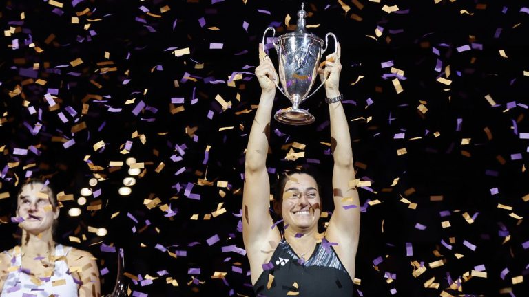 Caroline Garcia, right, of France, holds the trophy after defeating Aryna Sabalenka, left, of Belarus, in the singles final at the WTA Finals tennis tournament in Fort Worth, Texas, Monday, Nov. 7, 2022. (Ron Jenkins/AP)
