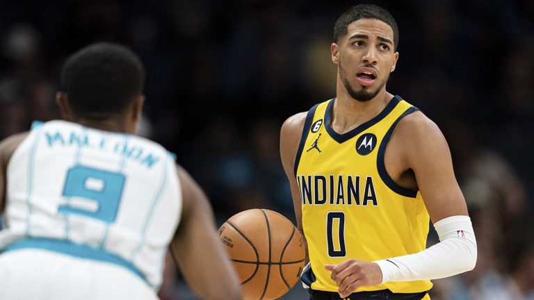 Indiana Pacers guard Tyrese Haliburton (0) brings the ball up while guarded by Charlotte Hornets guard Theo Maledon during the second half of an NBA basketball game in Charlotte, N.C., Wednesday, Nov. 16, 2022. (Jacob Kupferman/AP)