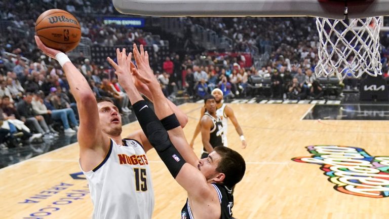 Denver Nuggets center Nikola Jokic, left, shoots as Los Angeles Clippers center Ivica Zubac defends during the first half of an NBA basketball game Friday, Nov. 25, 2022, in Los Angeles. (Mark J. Terrill/AP)