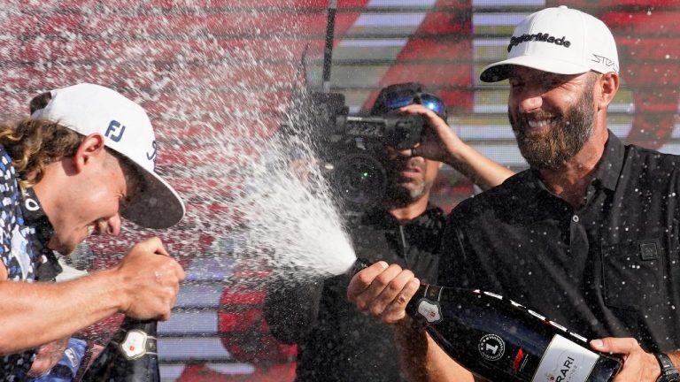 Cameron Smith, left, and Dustin Johnson, right, celebrate after the final round of the LIV Golf Team Championship at Trump National Doral Golf Club, Sunday, Oct. 30, 2022, in Doral, Fla. Johnson's 4 Aces GC team won the team championship. (AP Photo/Lynne Sladky)