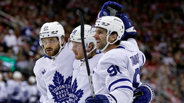 Toronto Maple Leafs center John Tavares (91) celebrates his goal against the New Jersey Devils with Rasmus Sandin (38) and Timothy Liljegren (37) during the first period of an NHL hockey game Wednesday, Nov. 23, 2022, in Newark, N.J. (Adam Hunger/AP)