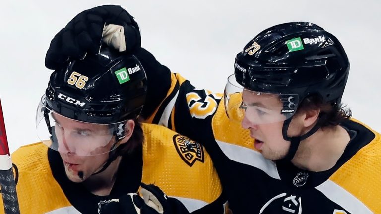 Boston Bruins' Erik Haula (56) celebrates his goal with teammate Charlie McAvoy (73) during the first period of an NHL hockey game against the Columbus Blue Jackets, Saturday, April 2, 2022, in Boston. Michael Dwyer/(AP Photo)