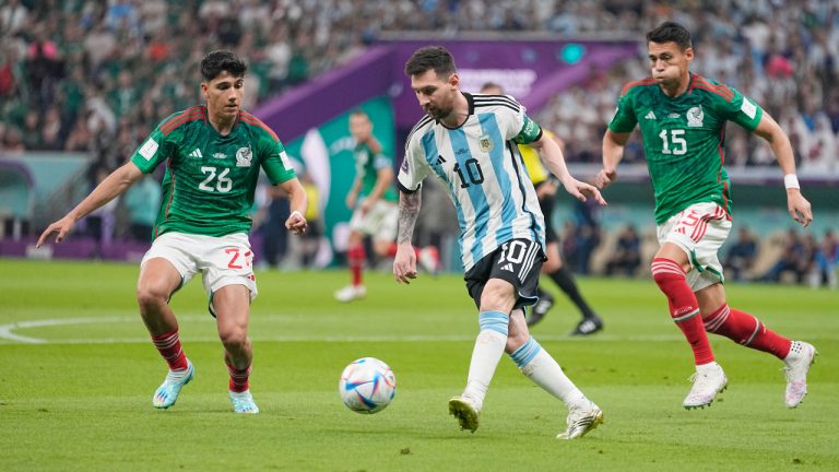 Argentina's Lionel Messi, center, tries to dribbles past Mexico's Kevin Alvarez, left, and Mexico's Hector Moreno during the World Cup group C soccer match between Argentina and Mexico, at the Lusail Stadium in Lusail, Qatar, Saturday, Nov. 26, 2022. (Ariel Schalit/AP)