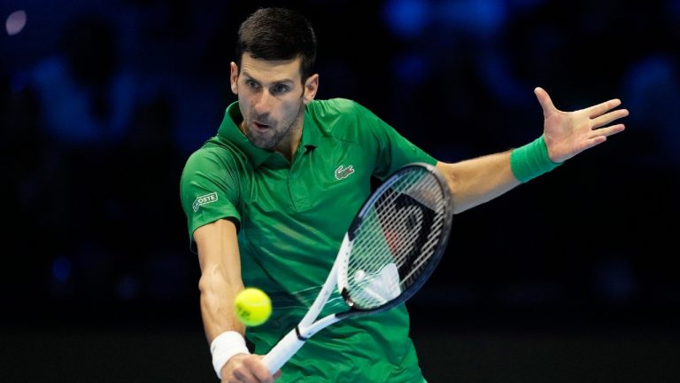 Serbia's Novak Djokovic returns the ball to Greece's Stefanos Tsitsipas during their singles tennis match of the ATP World Tour Finals, at the Pala Alpitour in Turin, Italy, Monday, Nov. 14, 2022. (Antonio Calanni/AP)