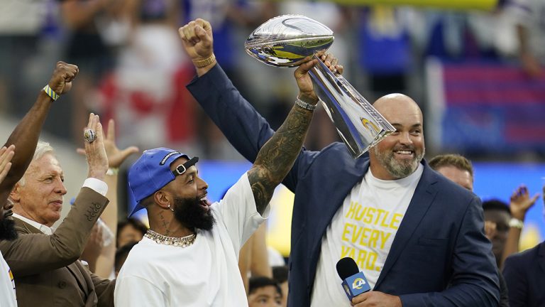 Former Los Angeles Rams wide receiver Odell Beckham Jr., center, lifts the 2021 championship trophy next to ex-player Andrew Whitworth, right, and team owner Stan Kroenke, left, before an NFL football game against the Buffalo Bills Thursday, Sept. 8, 2022, in Inglewood, Calif. (Ashley Landis/AP)